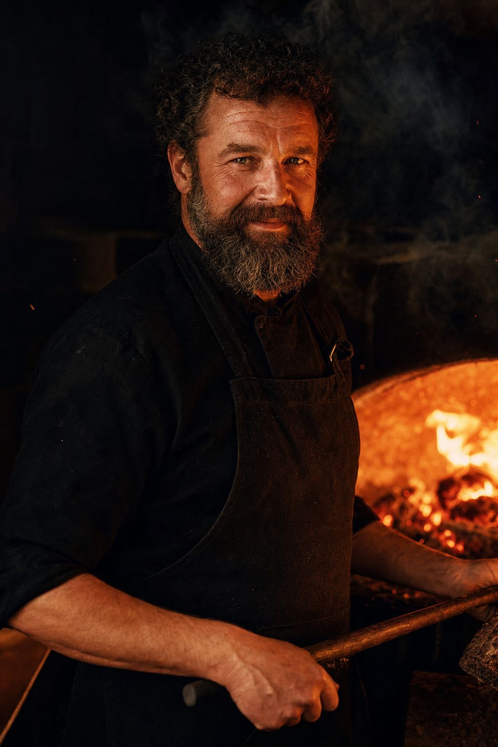 Elias Rourke, Founder & Head Chef at ember, fire-lit at the hearth